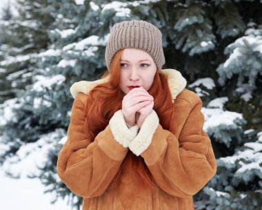 Genç kadın eller kış açık ısıtır.