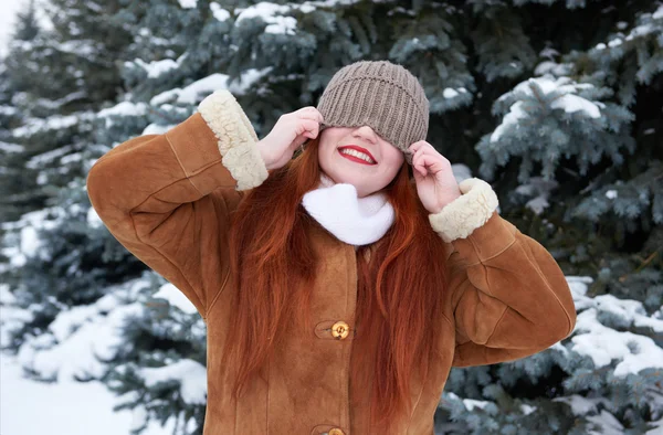 Winter woman outdoor portrait with cap covering eyes — Stock Photo, Image