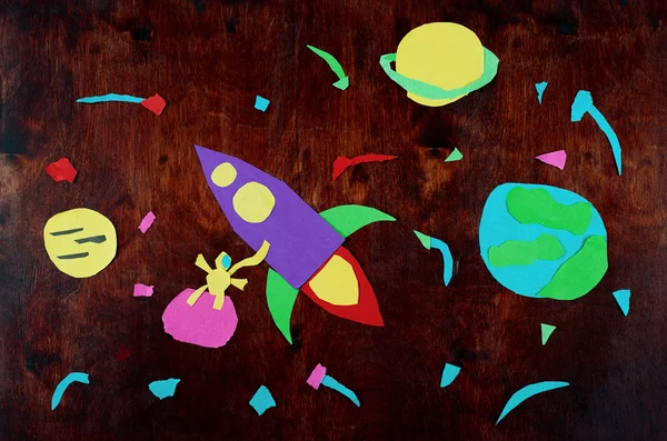 Spaceship in space. Applique made by child from paper on wood. — Stock Photo, Image