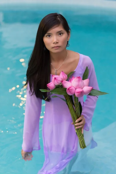 Pretty Vietnamese woman standing in water — Stock Photo, Image