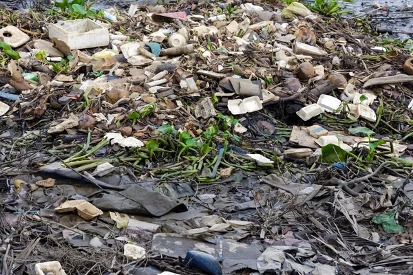 Inquinamento dei rifiuti sulle rive di un fiume — Foto Stock