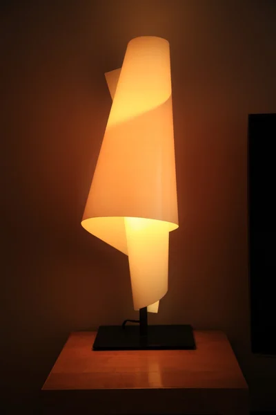 Modern lamp on table at night — Stock Photo, Image