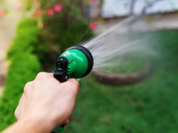 Garden hose and spray gun — Stock Photo, Image