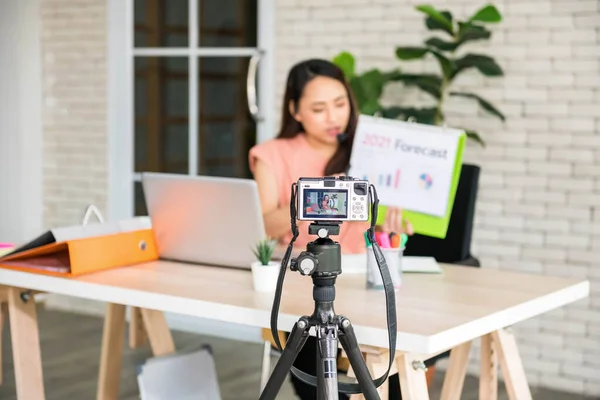 mirorless camera record video blog of businesswoman or Professional coach trend and 2021 business forecast. Online class for videoblog channel training during covid-19. focus on camera.