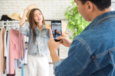 Adam akıllı telefondan video yayınını kaydediyor. Moda blogcusu ya da Stüdyoda satmak için şapka takan stilist kız. Video kanalı için trend kadın video bloğu bölümü. Düşünce lideri eğilimi.