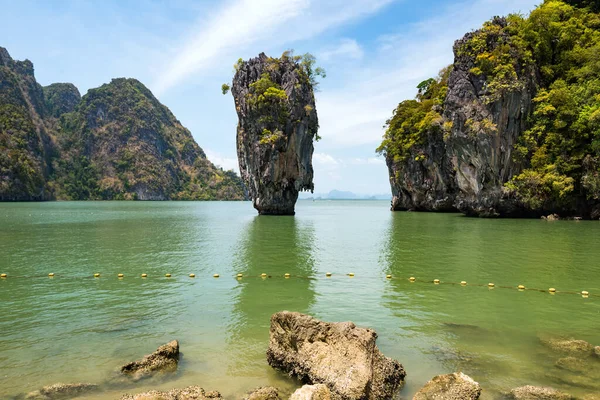 James Bond island or khao nail, called Tapoo in Thai, famous landmark movie of Man with Golden Gun and sailing boat at Ao Phang Nga bay, Thailand. Famous travel destination or summer holiday maker.