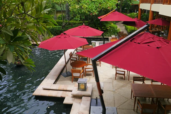 Luxury bar with red parasols — Stock Photo, Image