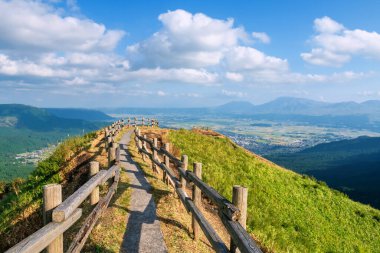Nishiyunouraenchi Gözlemevi 'nin ikonik zirve ahşap yürüyüş yolu Aso volkanik kalderasının kuzey kenarını görmek için Kuju Ulusal Parkı' na karşı mavi gökyüzü, Kumamoto, Japonya.