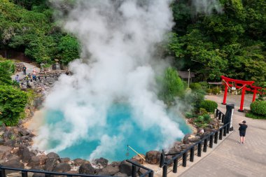 Umi Jigoku 'daki ya da Torii Kapısı, Beppu, Oita, Japonya' daki Deniz Cehennemi Kaplıcaları 'ndaki turistler. Kyushu 'nun kaynayan kaynak suyunun ünlü yolculuk yeri ve sekiz cehennemin ünlü fotojeniği..
