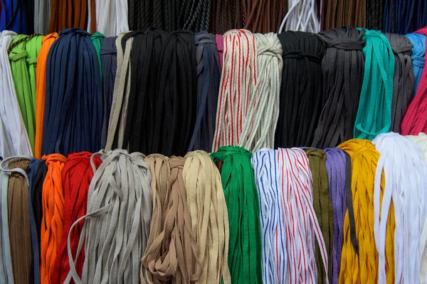 Multicolored shoelaces for textured background — Stock Photo, Image