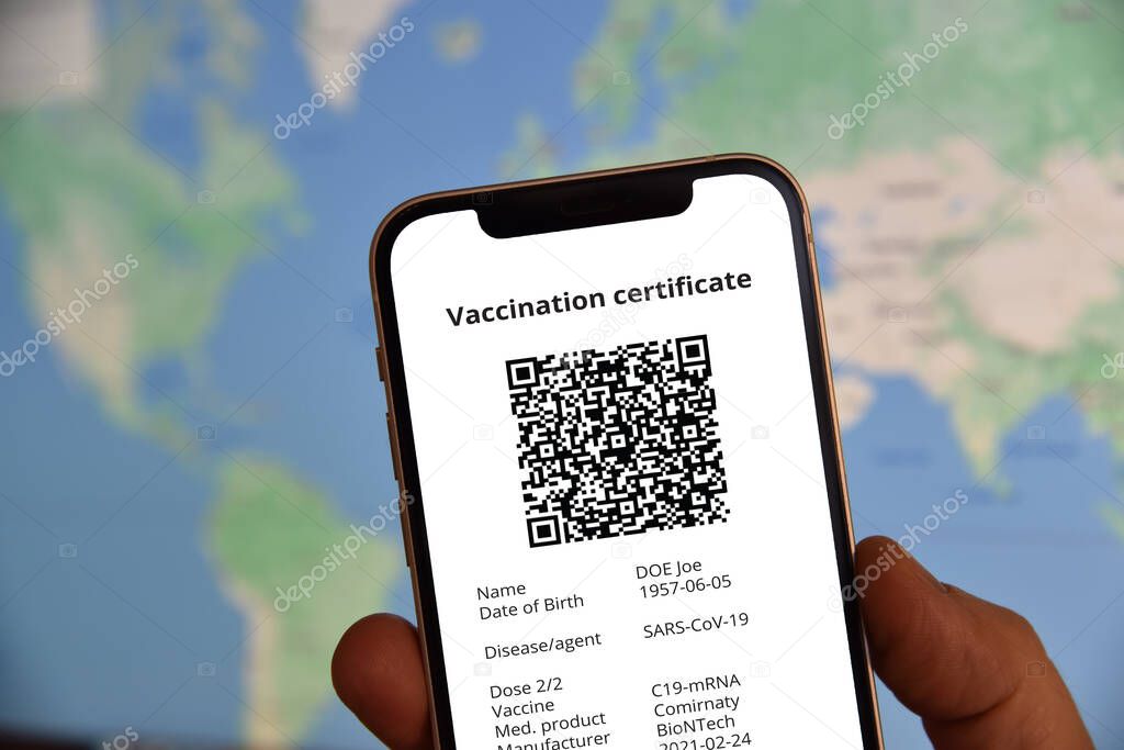 Mobile phone  with digital certificate of vaccination against Covid-19 in front of the world map. Travel and tourism concept during coronavirus pandemic.