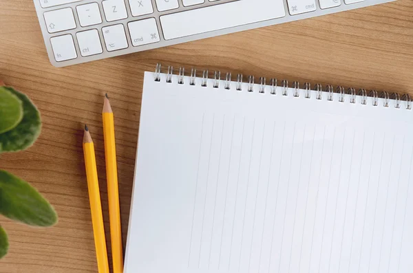 Top view of desktop with computer, supplies, flower and blank notepad copy space — Stock Fotó