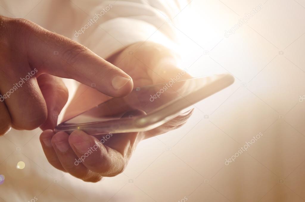 Closeup of businessman using modern smartphone