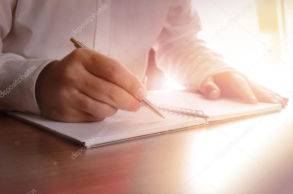 Concept of a businessman writing on a notebook