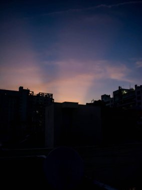 Şehir manzarası üzerinde gün batımı, renkli gökyüzü arkaplanı