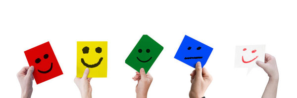 Collection of hands holding a paper with smiley face isolated on white background.