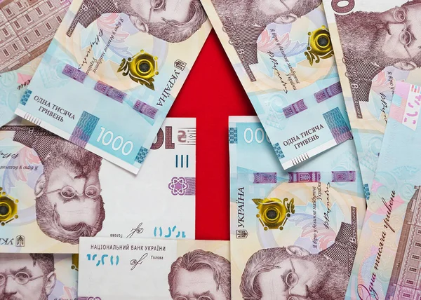一支箭头 内衬乌克兰格里夫尼亚和欧元的钞票 图库图片