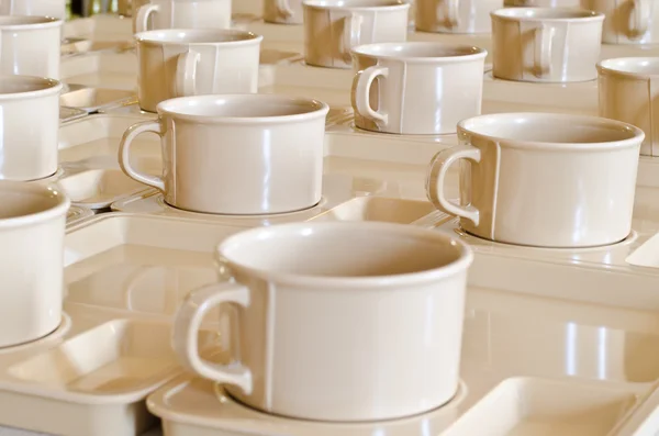 Group of coffee cups on plates — Stock Photo, Image