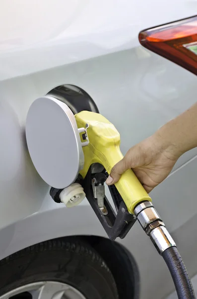 Grey car at gas station being filled with fuel — Stock Photo, Image