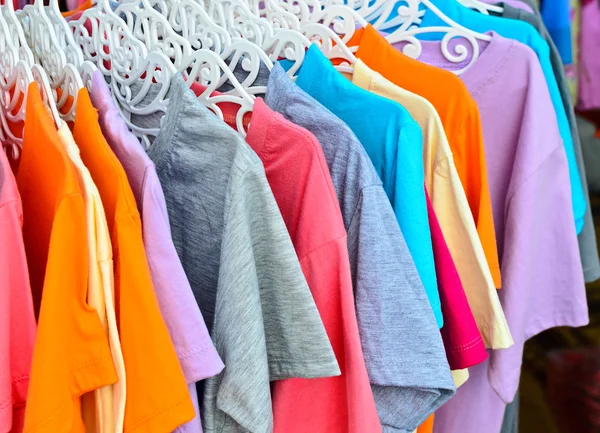 Colorful t-shirt on hangers Stock Photo