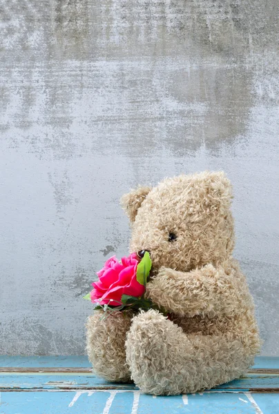 Sevimli ayı bebek tutan gül buketi