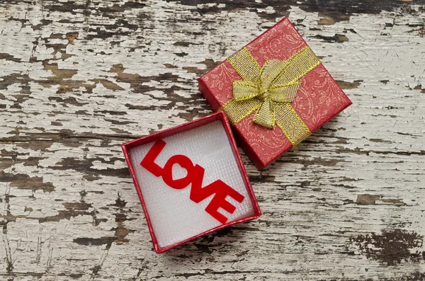 Love alphabet in gift box on grunge wood background — Stock Photo, Image