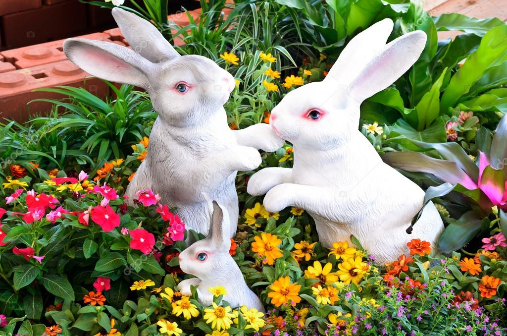 Three rabbit sculptures in garden