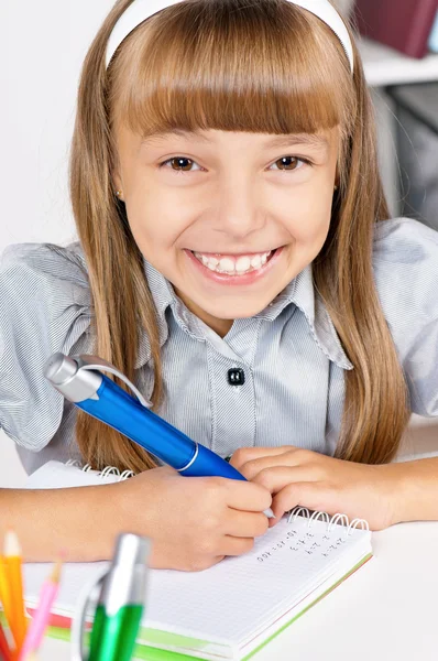 Mała dziewczynka siedzi przy biurku w klasie — Zdjęcie stockowe