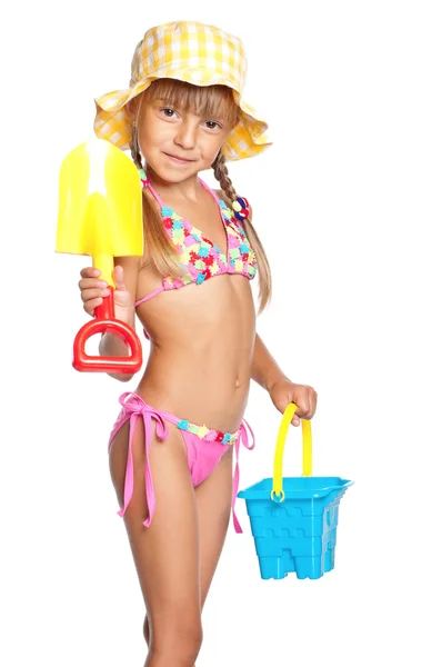 Bambina in costume da bagno con giocattoli — Foto Stock