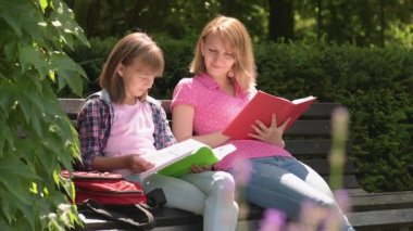 Mother and daughter reading books