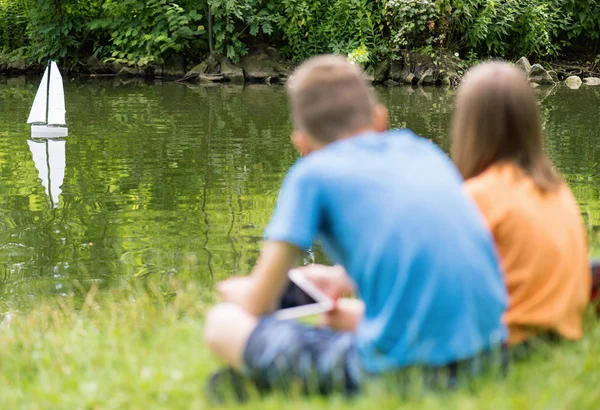 Kinderen met externe gecontroleerde boot — Stockfoto