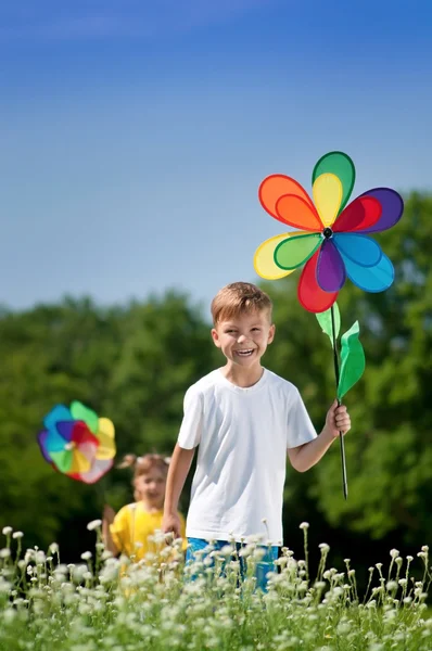 Дети с разноцветным флюгером — стоковое фото