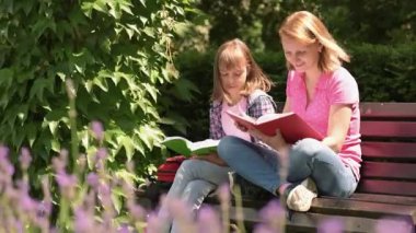 Mother and daughter reading books