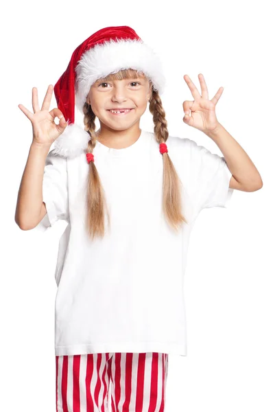 Petite fille dans Santa chapeau montrant ok — Photo