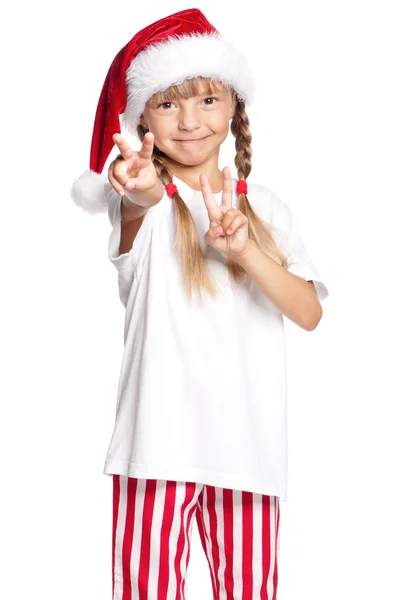 Little girl in Santa hat showing victory — Stock Photo, Image