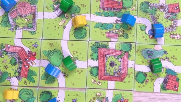 4k Board game and kids leisure concept - kids hands playing wood chips people figure in children table top game carcassonne - 11jan21 St.Petersburg Russia — Αρχείο Βίντεο