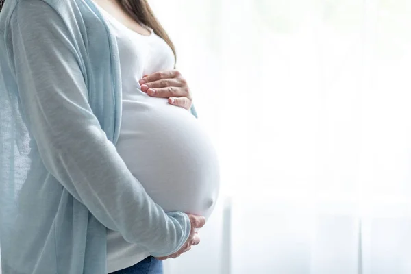 Healthy pregnancy. Side view pregnant woman with big belly advanced pregnancy in hands. Banner copyspace for text. Elegant mother waiting baby. — Stock Photo, Image