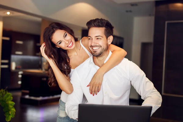 Successful young couple laughing indoor — Stock Photo, Image