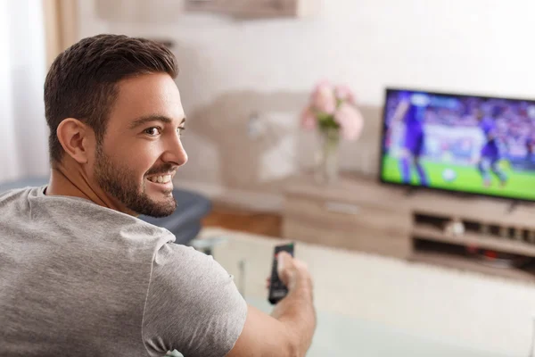 Excited man switch TV to soccer