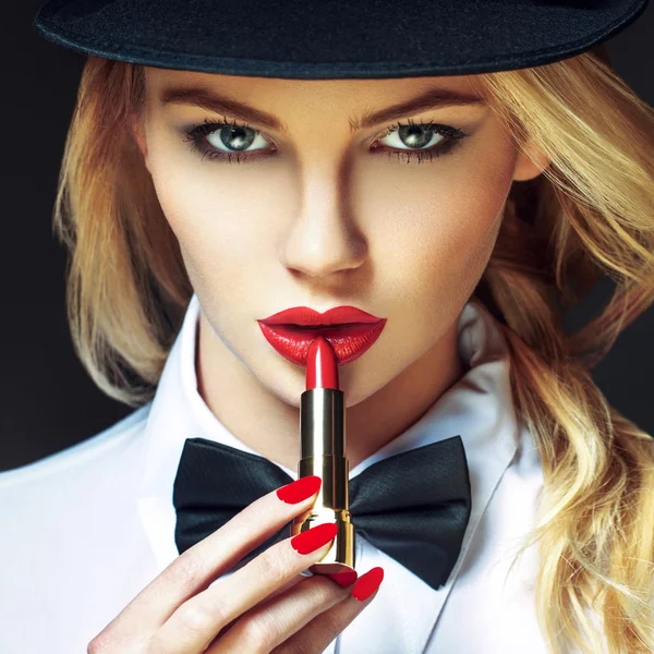 Sexy blonde woman with red lips and nails applying lipstick — Stock Photo, Image