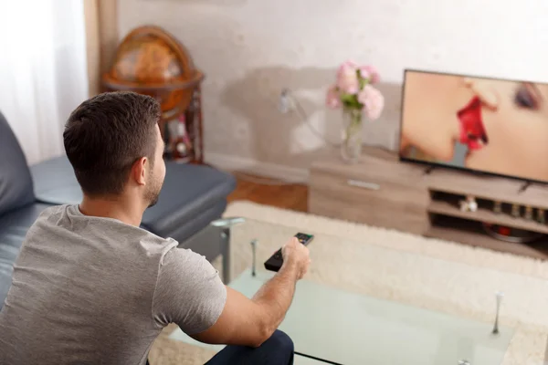 Man watching sex movie in TV — Stock Photo, Image