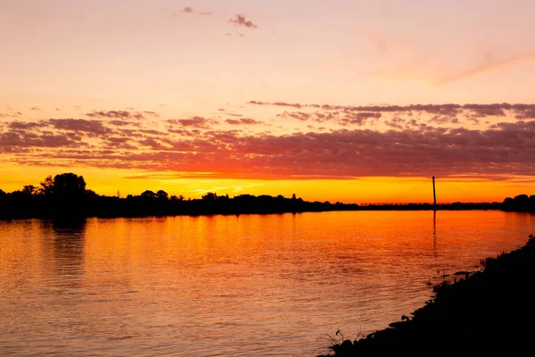 Colorful golden sunset at riverbank of Danube, Komarom, Hungary