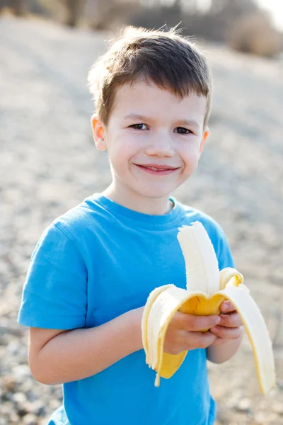 Little boy with banana — Stock Photo, Image