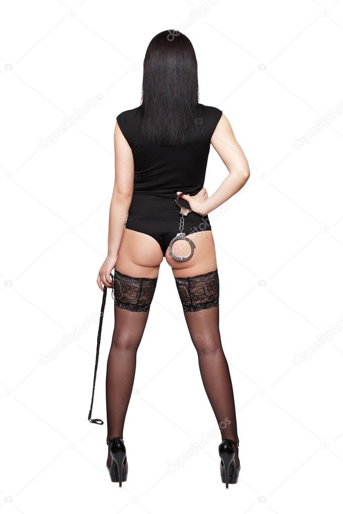 Sexy woman dominatrix with sex toys back view