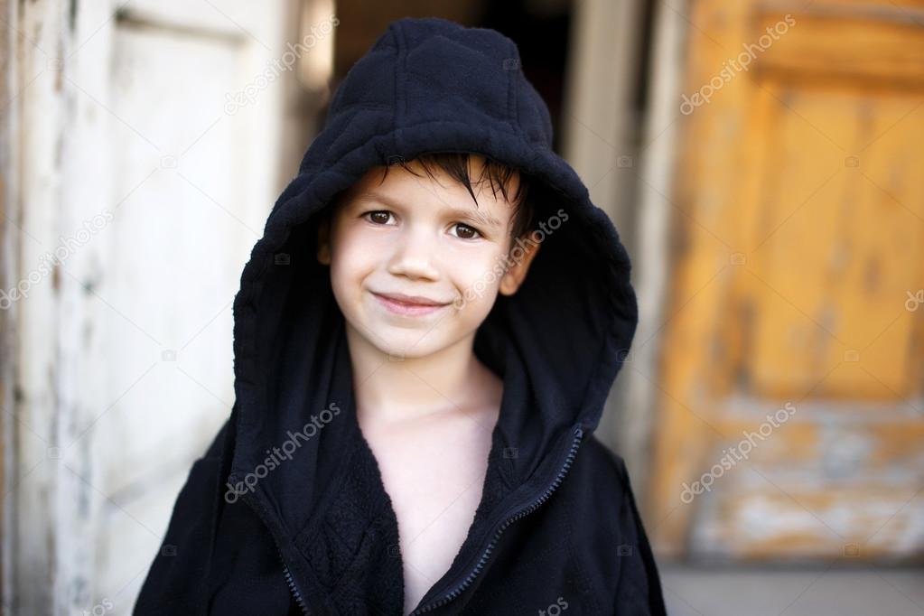 Little boy in black bathrobe drying