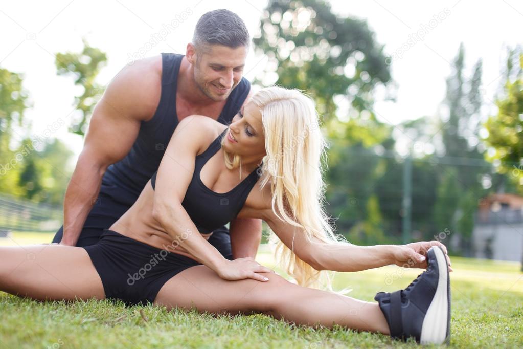 Young couple exercising and stretching
