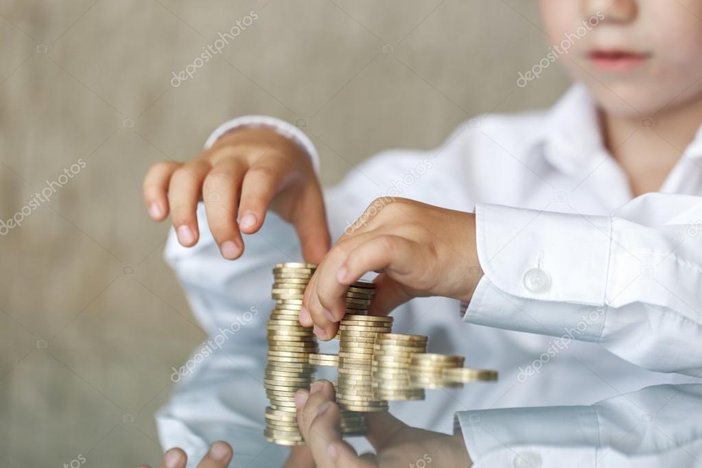 Little boy counting one euro column