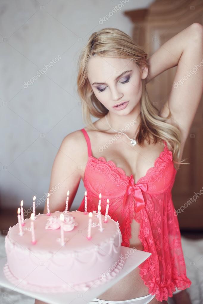 Sexy blonde woman in pink bra with birthday cake Stock Photo by  ©sakkmesterke 85157060