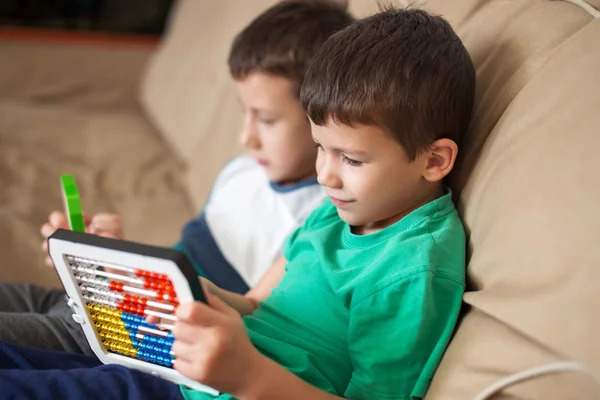 Little boys learn counting on abacus at home — Stock Photo, Image