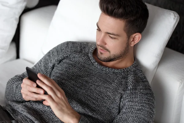 Fashionable man reading message on smartphone — Stock Photo, Image